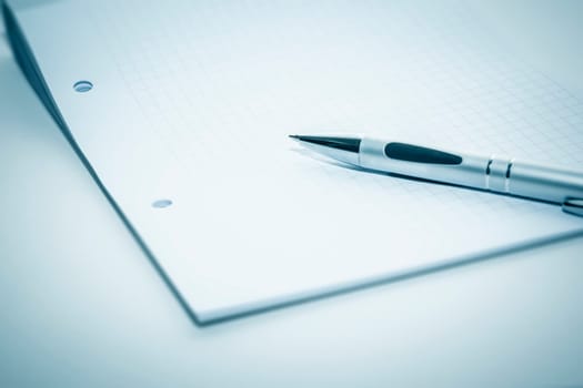 An image of a notepad and a ballpen