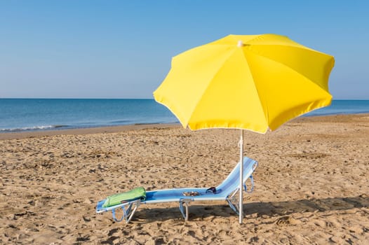 umbrella on the beach, with sun and sea on background