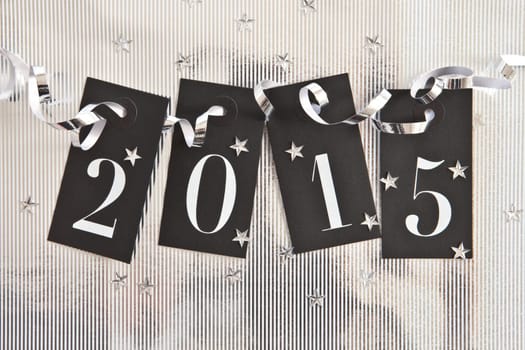 2015 on silver background with star confetti