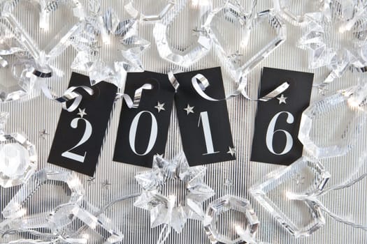 2016 on silver background with star confetti