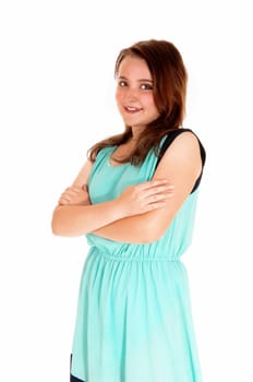 A portrait picture of a pretty teenage girl in a turquoise dress with her arms.crossed, isolated for white background..