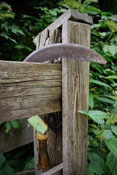Sickle hangs on the fence