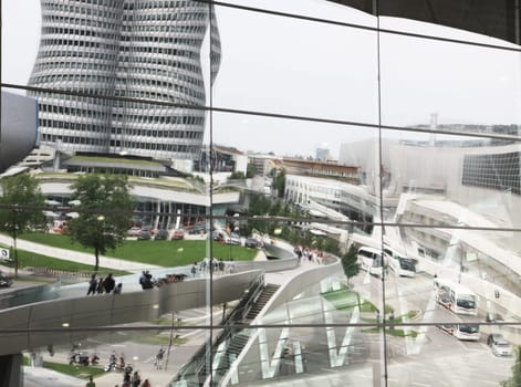 Munich Olympia park, cityscape with the BMW headquarters reflecting on the glass facade of the BMW Welt building