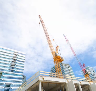 construction site with two cranes on a building