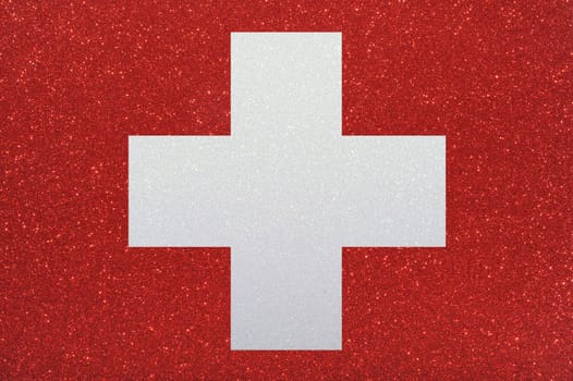 The swiss flag made of sparkling glitter material