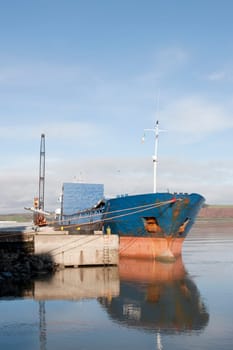 large ship being loaded with steel by crane at Youghal pier county Cork, Ireland