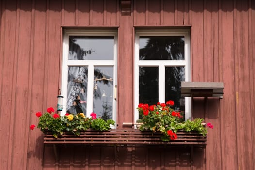 small window with flower boxes and front bell house