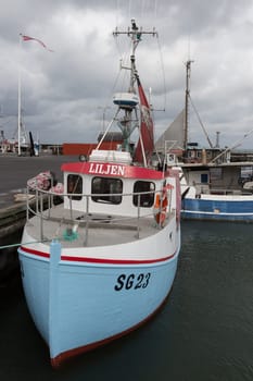 Small blue fishing boat in the port of Bagenkop
