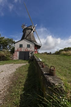 Windmill with miller's house and a garage. Weights on the wall