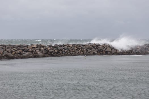 Waves hit the breakwater in the port of Bagenkop,Langeland