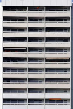 The photograph of a high-rise facade with symmetrically arranged balconies.