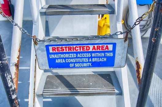 Caution sign, restricted area on steel stair