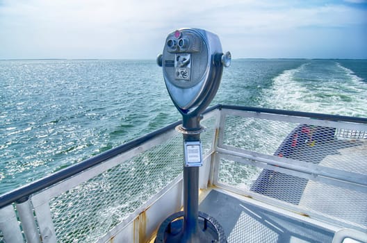 Binoculars watching at horizon on ship deck