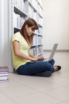 Student using laptop in library