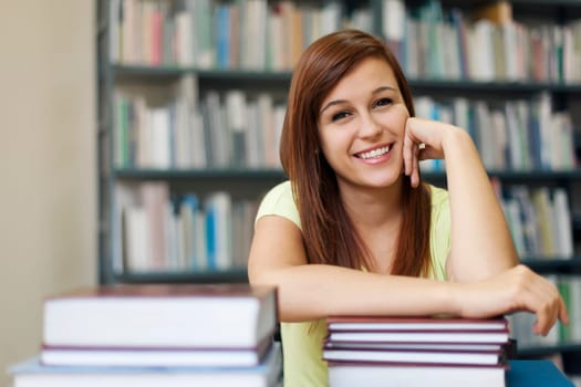 Portrait of young student woman in library