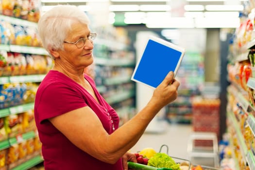 Senior woman reading description on the box