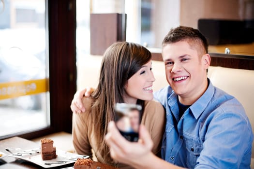 Couple taking picture in cafe