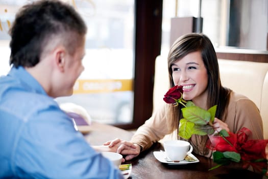 Young man giving a rose his girlfriend