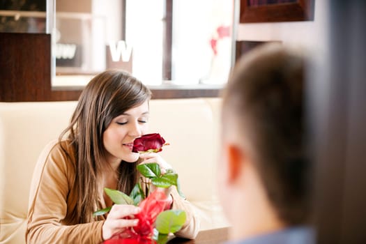 Young man giving a rose his girlfriend