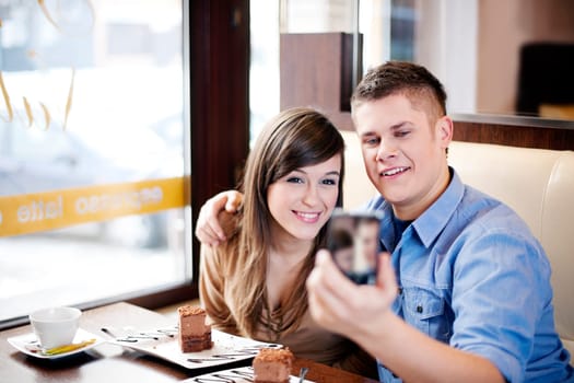 Couple taking picture in cafe