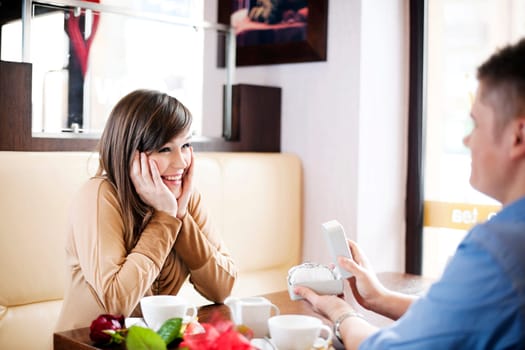 Young man giving a watch his girlfriend on Valentine's Day