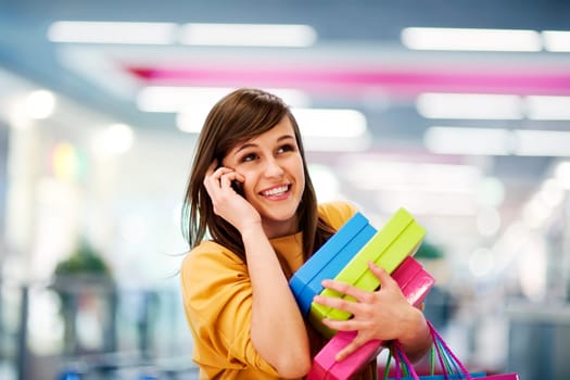 Beautiful woman on the phone in shopping mall