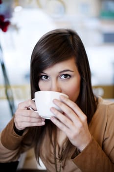 Close up of woman drinking coffee