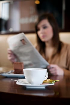 Reading newspaper in cafe