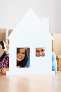 Happy couple with home sign