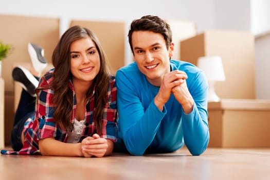 Portrait of young couple in their new home