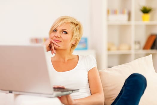 Portrait of pensive woman with laptop