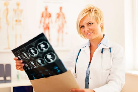 Young female doctor opening envelope with brain tomography result