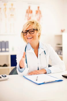 Portrait of smiling female doctor offering a handshake