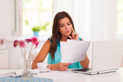 Thoughtful woman working at home