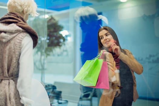 Young woman looking at shop window