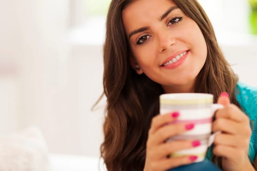 Beautiful smiling woman with cup of coffee