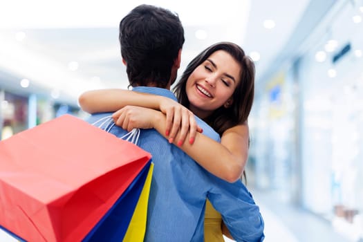 Young beautiful woman welcoming in shopping mall