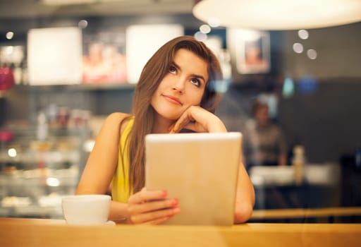 Young woman dreaming in cafe