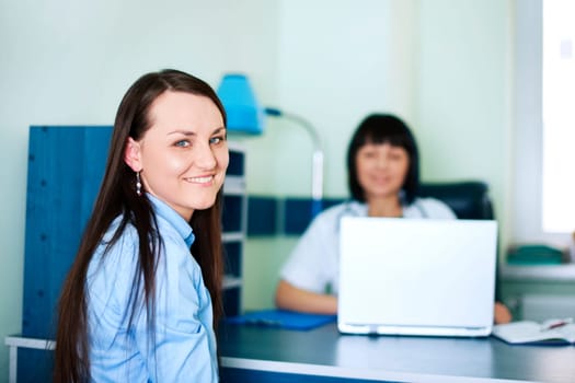 Smiling young women at doctors office