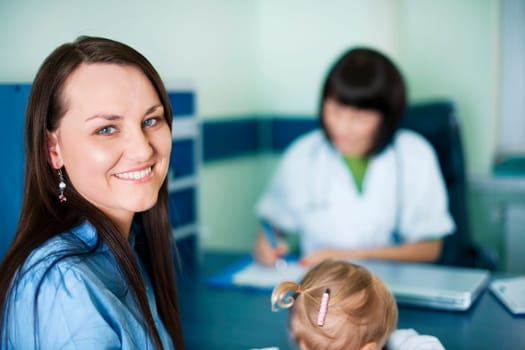 Smiling mother with her child at doctors office