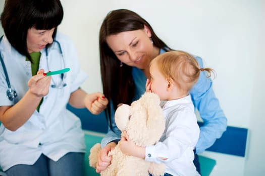 Doctor trying to exam baby's throat