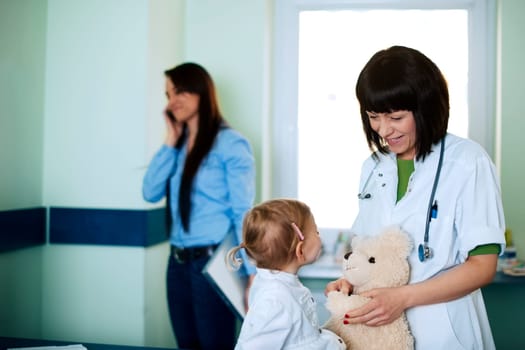 Busy businesswoman taking her daughter to the doctor