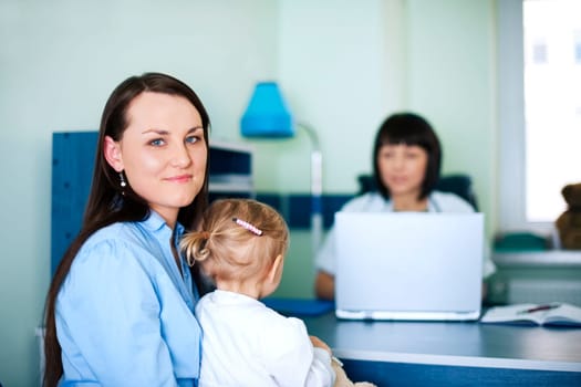Mother and daughter with doctor in hospital