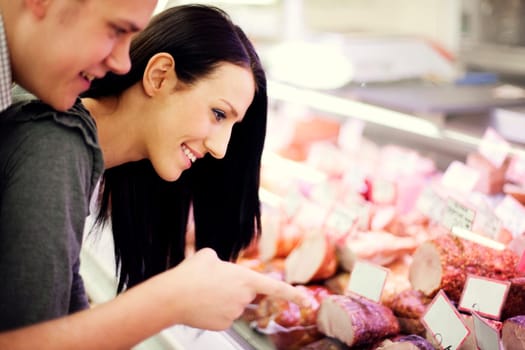 Young couple in butchers shop