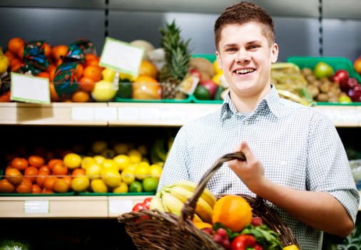 Young man standing the front of shopping shelves