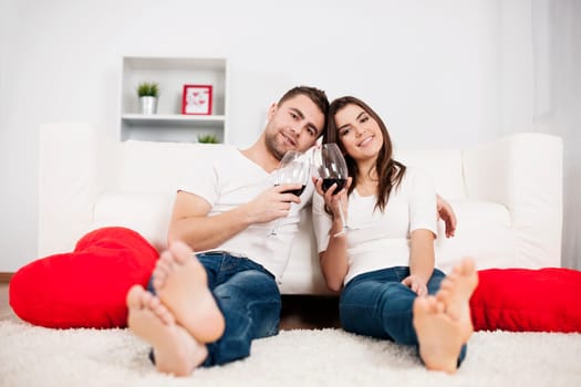 Romantic couple drinking wine at home