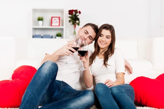 Romantic couple drinking wine at home