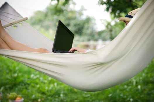 Working on hammock with laptop