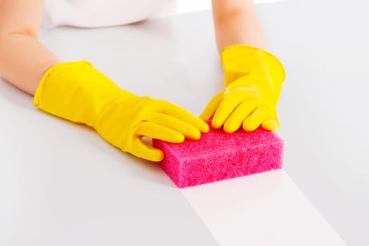 Cleaning table with pink sponge and protective glove