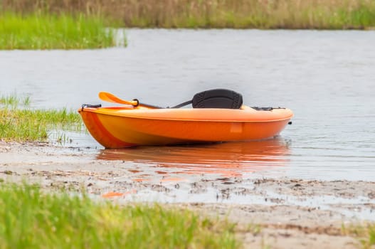 orange kayak on pamlino sound beach in north carolina